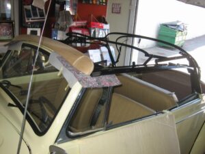 preparing to install a convertible top on this Volkswagen bug